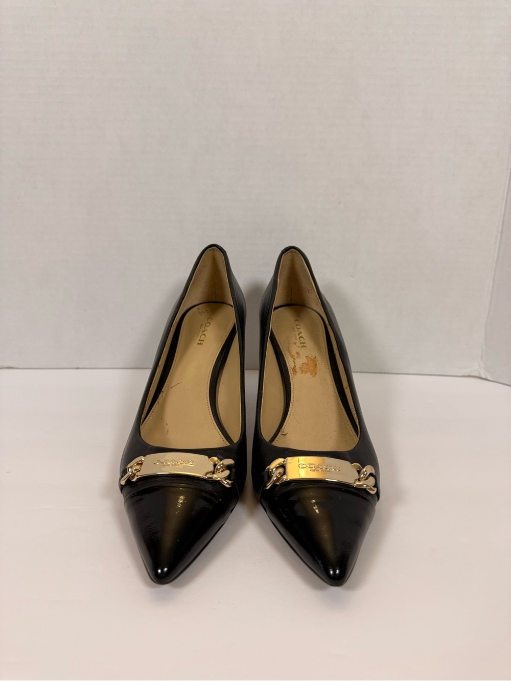 Coach Black Leather Pointed Toe Pumps with Gold Plaque